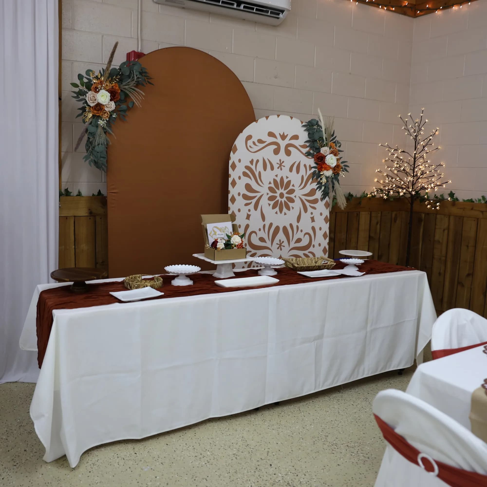 Dessert and welcome table styled with floral arches